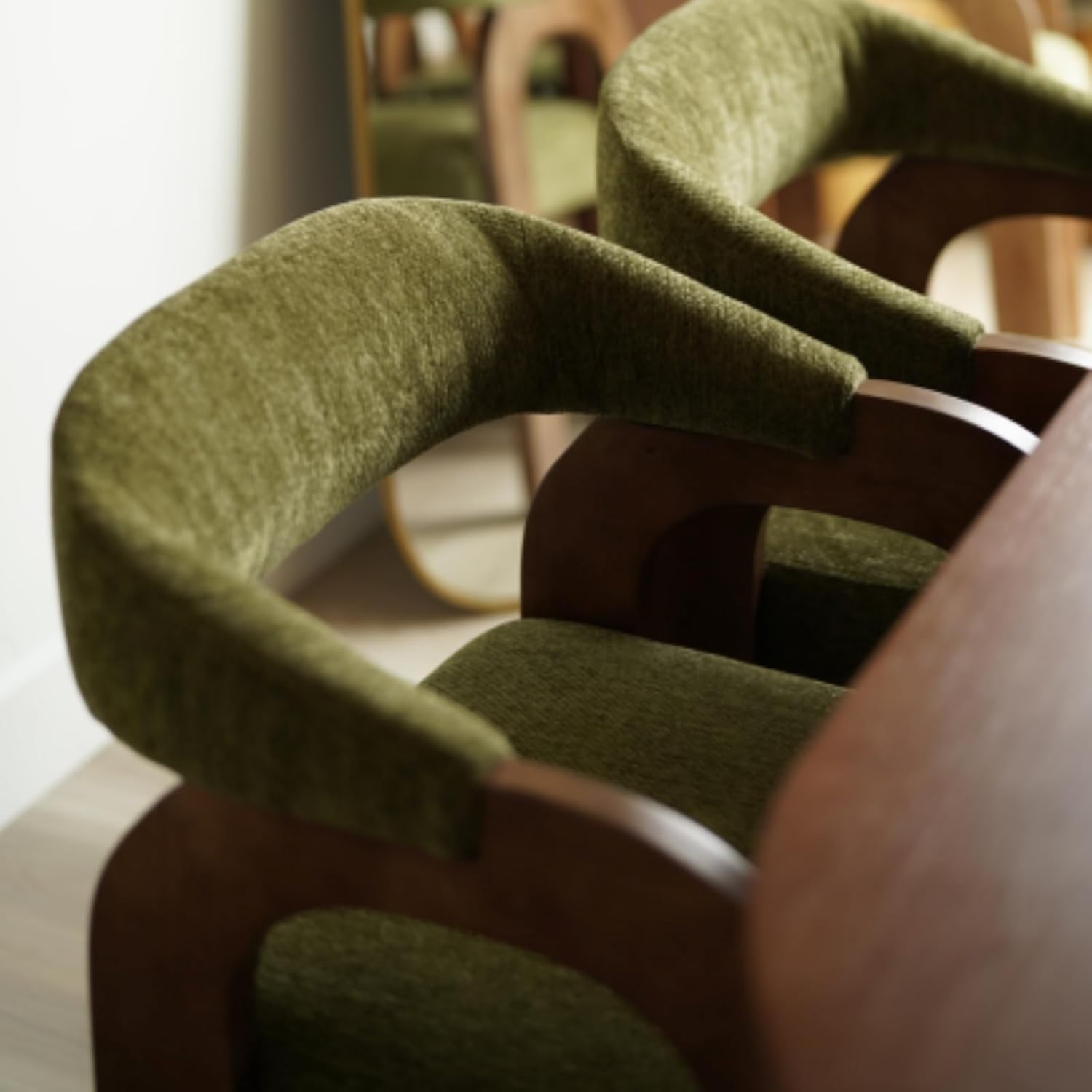 Close-up of the curved chenille armrests and wood frame on a DAYALANE Farmhouse Dining Chair