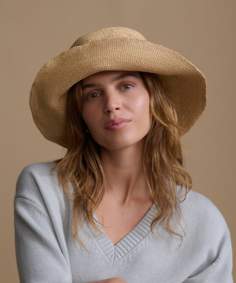 Jenni Kayne Crochet Raffia Sun Hat in natural on a beige background