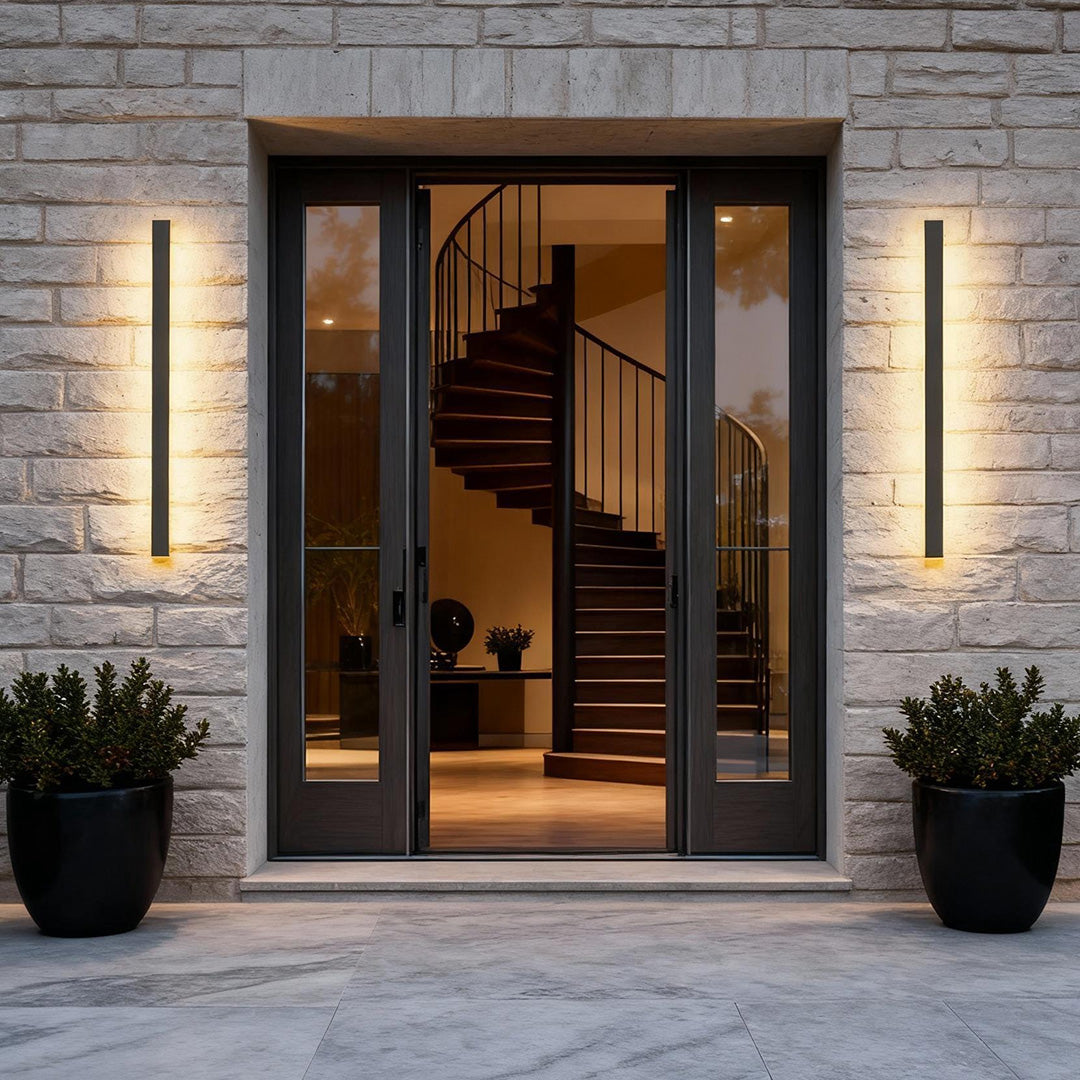Dazuma Outdoor Strip Wall Light installed beside a modern house entrance with a warm vertical glow