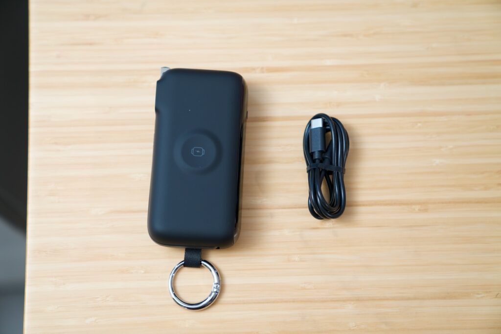 RORRY Flow portable charger held in hand showing built-in USB-C cable